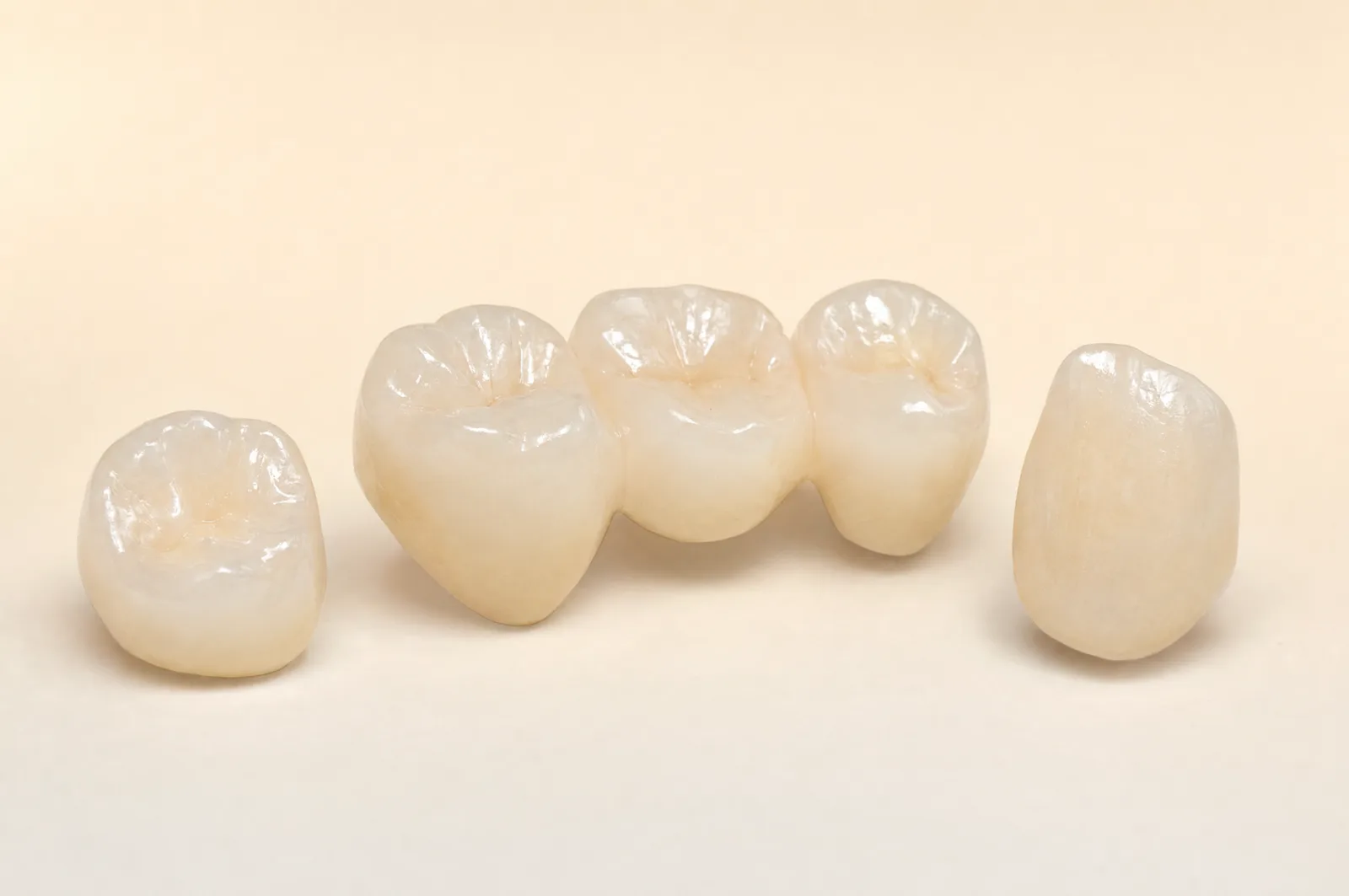 3D render: a group of translucent zirconia crowns and bridge units