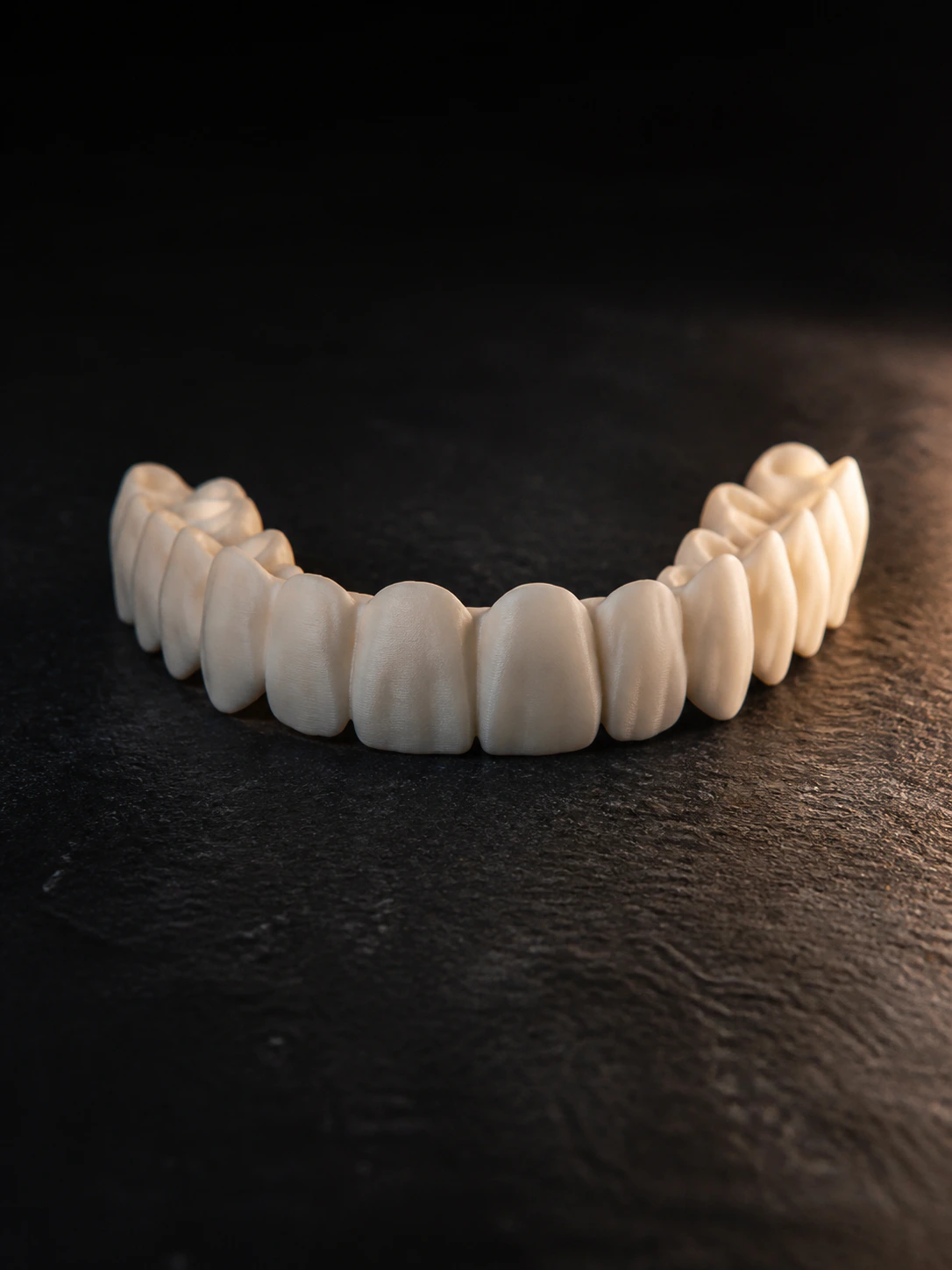 Close-up study of precisely finished ceramic dental work